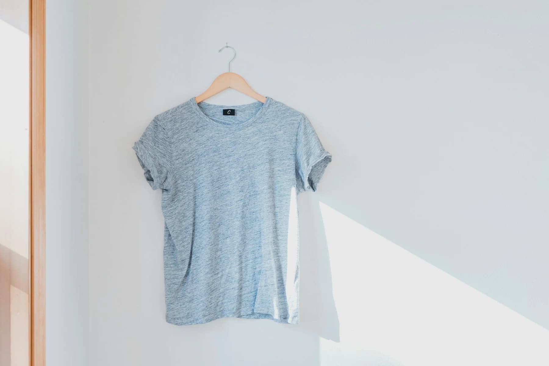 Heather grey crewneck t-shirt on a hanger