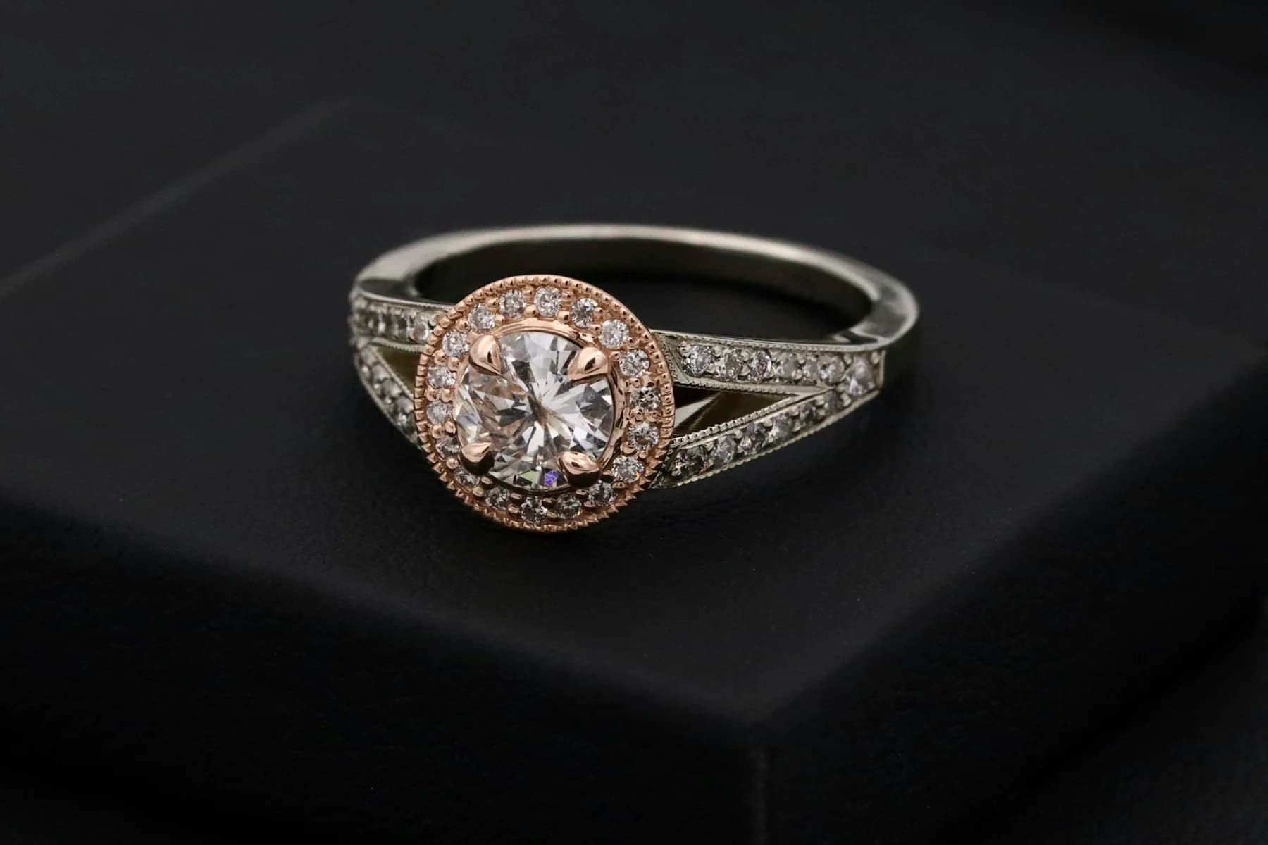 Diamond halo ring on a dark surface