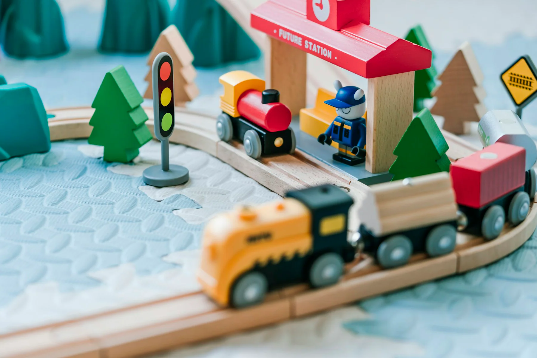 Colourful wooden toy railway set with a station
