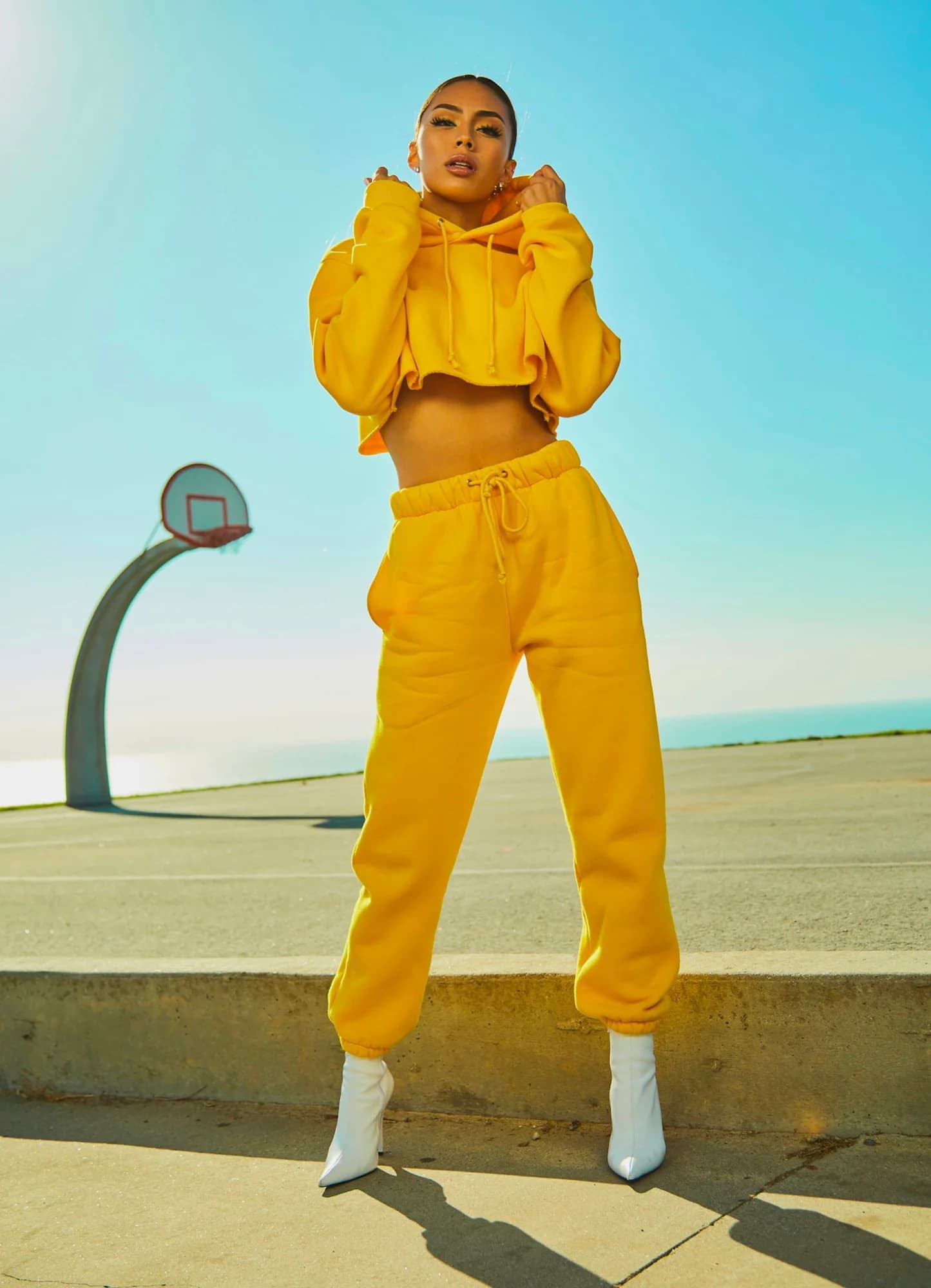 Woman wearing a yellow hoodie and jogger tracksuit set
