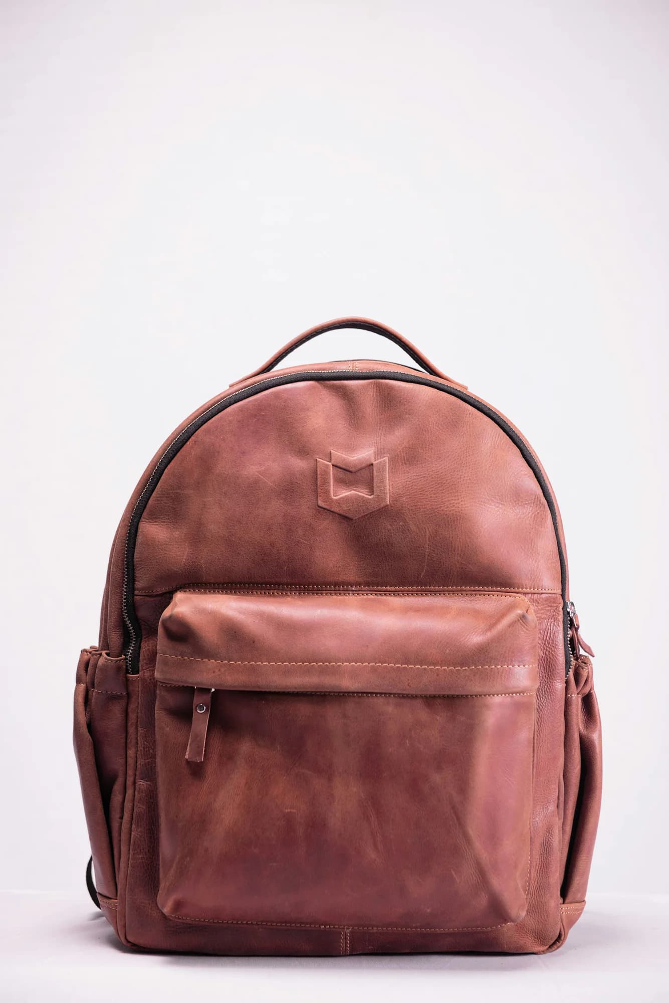 Brown leather backpack on a white background