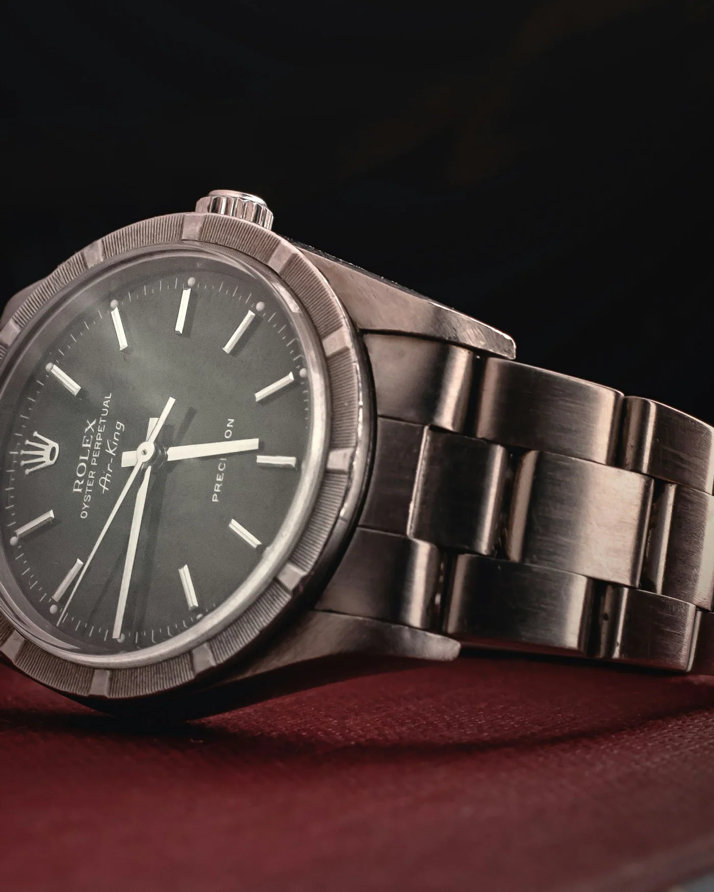 Stainless steel automatic watch with a dark dial — detail