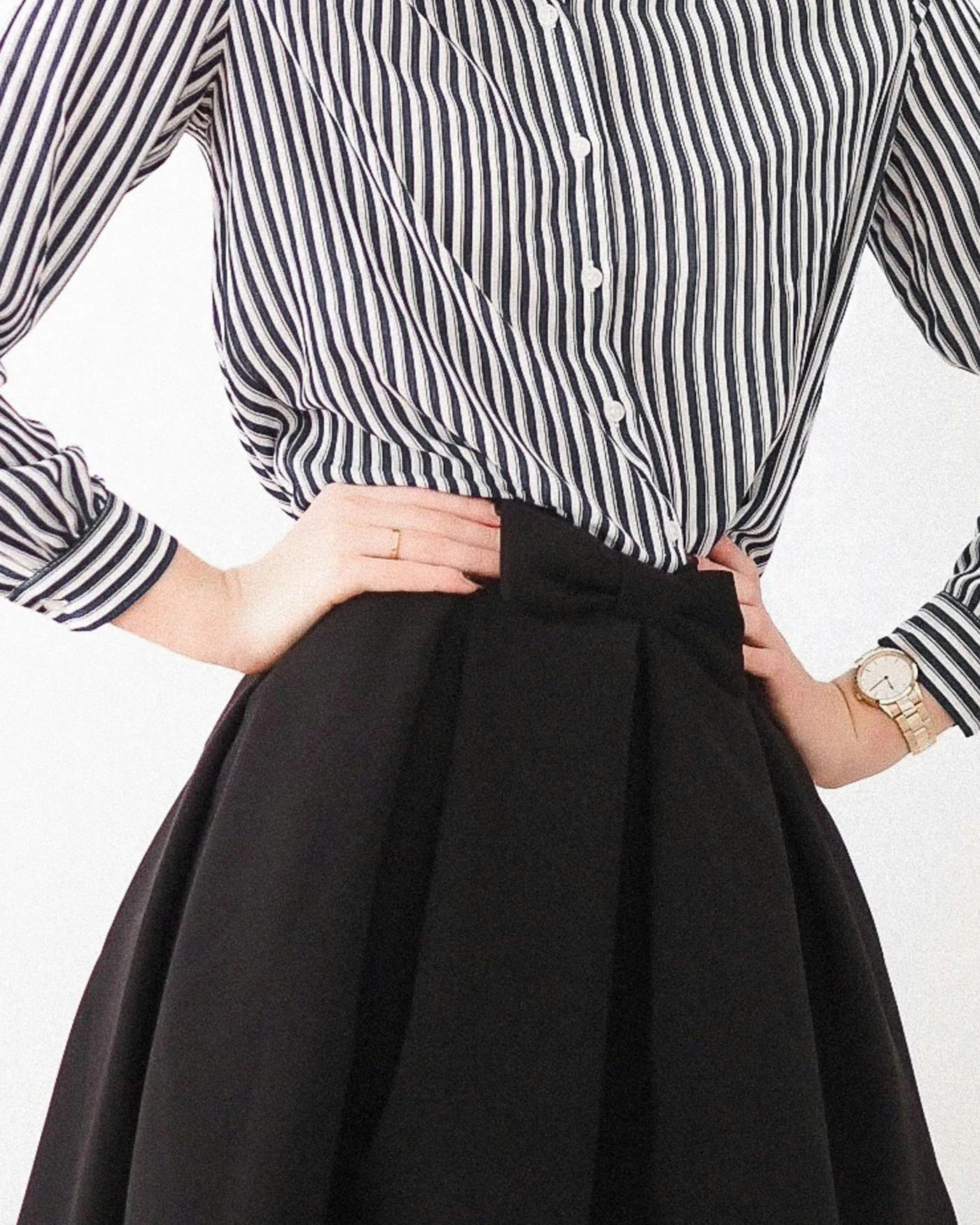 Woman in a striped shirt and black skirt — detail