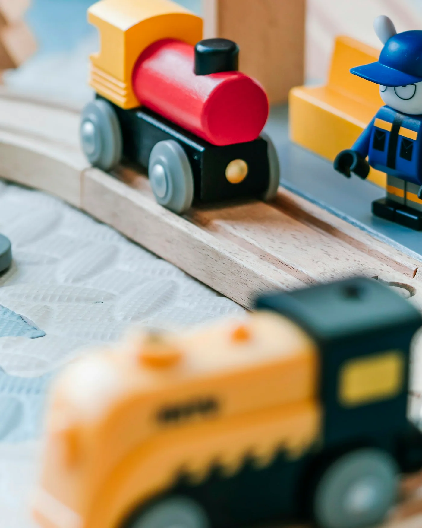 Colourful wooden toy railway set with a station — detail