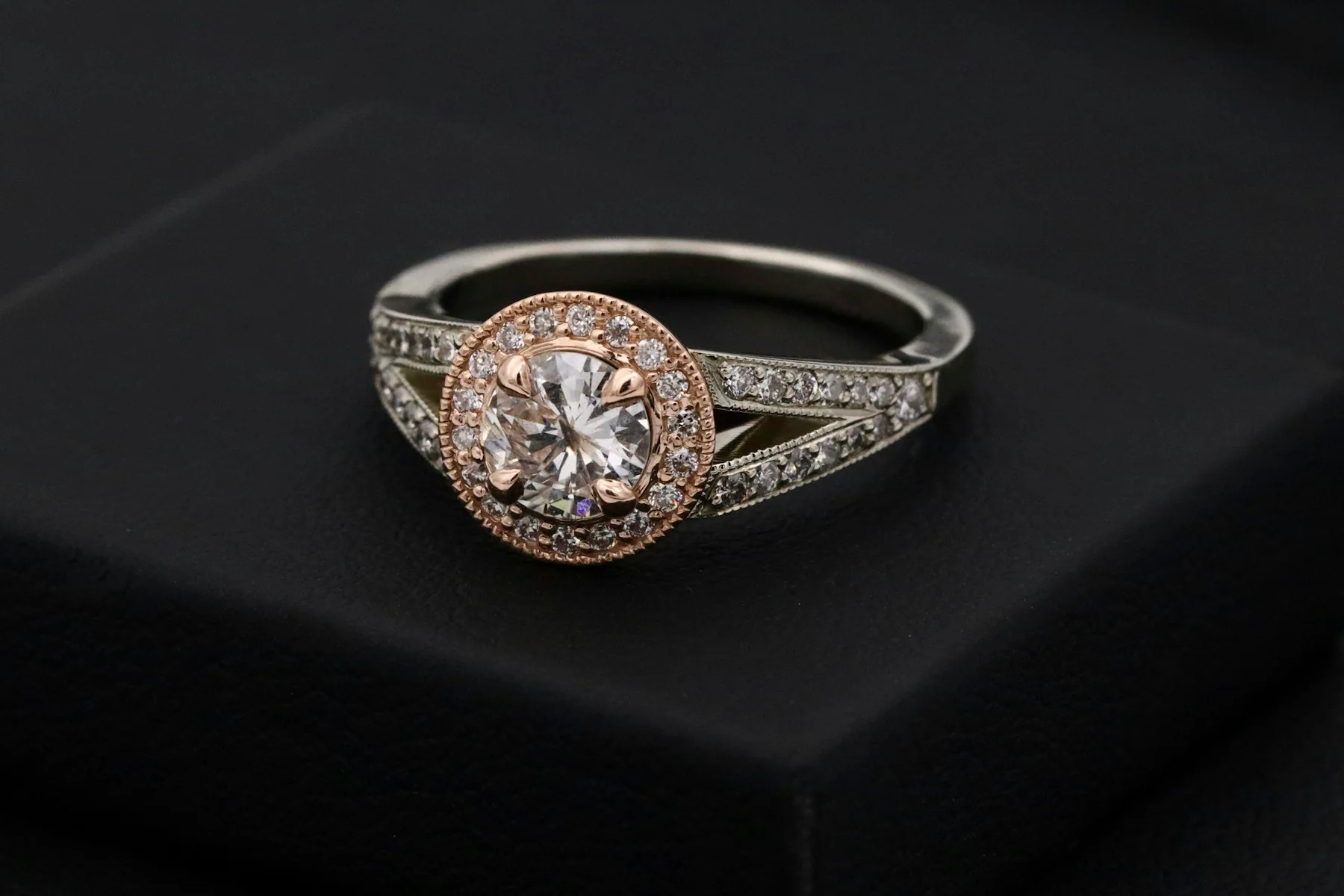 Diamond halo ring on a dark surface