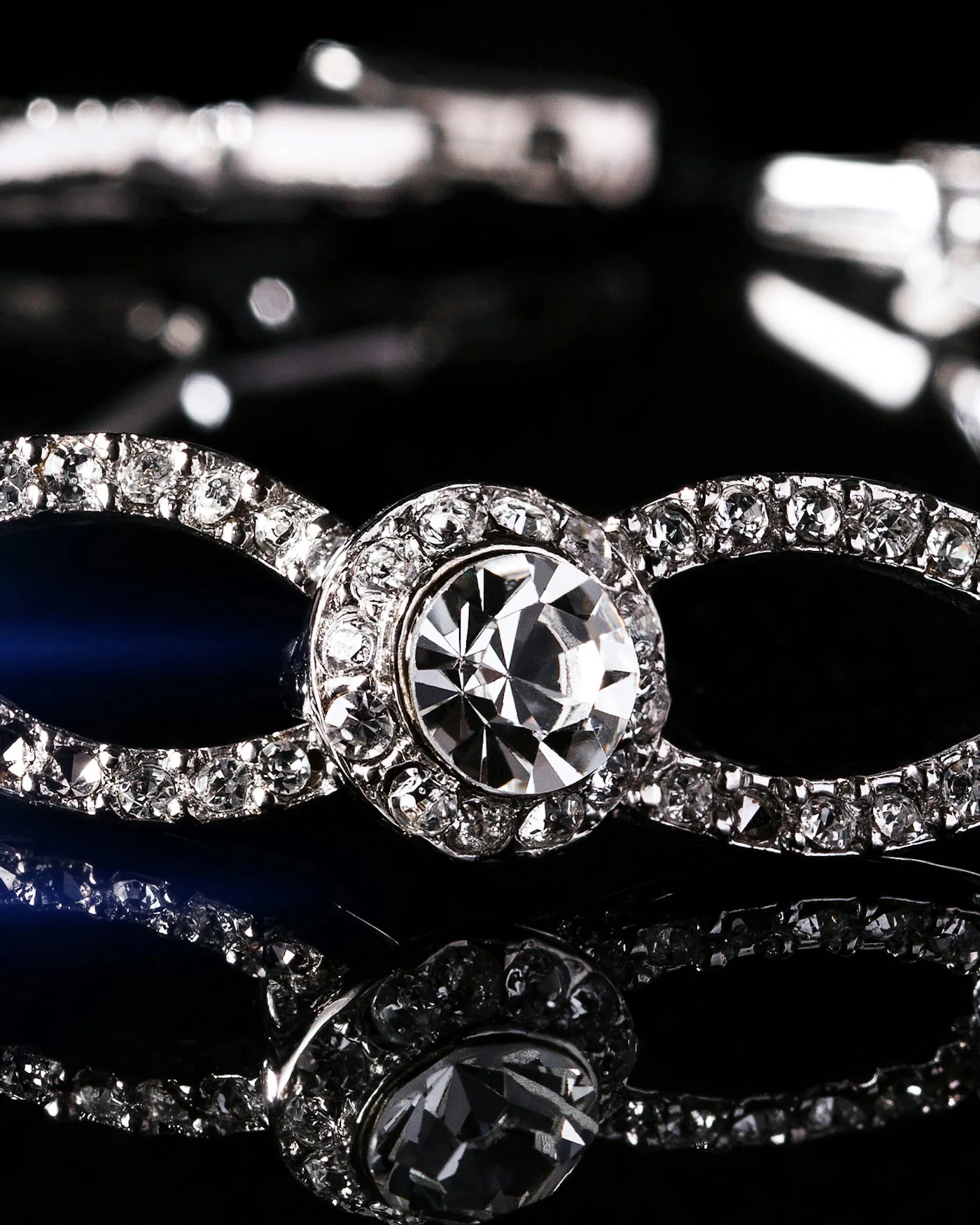 Sparkling crystal tennis bracelet on a dark background — detail