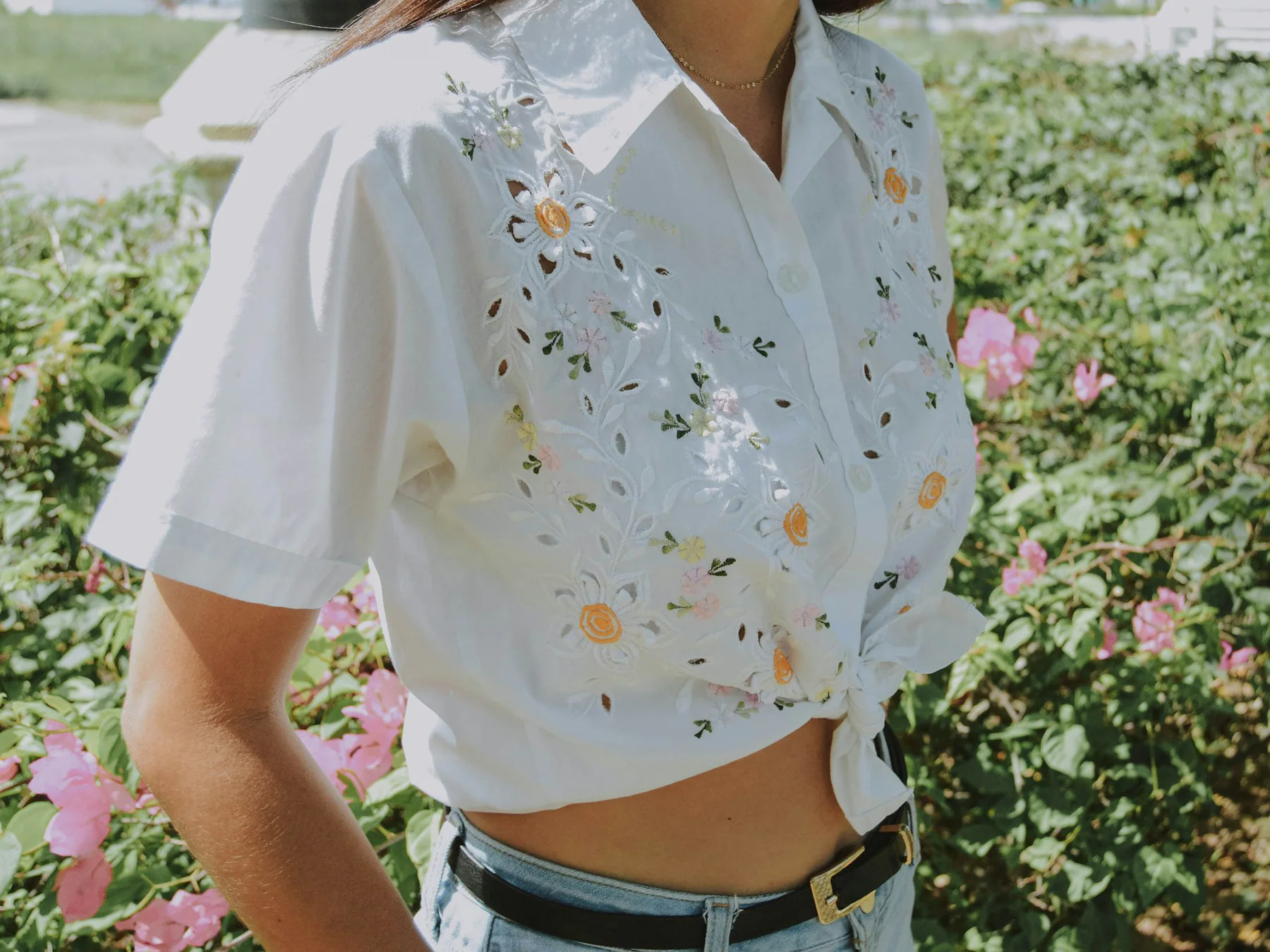 Close-up of a white blouse with floral embroidery